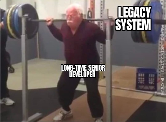 Gray haired man holding up a heavy barbell across jis shoulders. The barbell is labeled "Legacy system" and he is labeled "Long-time senior developer"