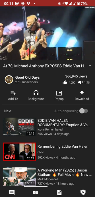 The screencap is a screenshot of a YouTube video page, viewed in tubular Android client. At the top, there is a video thumbnail showing two musicians on stage, one playing a guitar and the other a bass guitar. The video title reads "At 70, Michael Anthony EXPOSES Eddie Van H...". The channel name is "Good Old Days" with 27K subscribers, and the video has 366,945 views, 4.2K likes, and 1.7K dislikes. Below the video, there are options to add to playlist, play in background, open in popup, and download. The next video in the playlist is a documentary titled "EDDIE VAN HALEN DOCUMENTARY: Eruption & Va... Icons Remembered" with 55K views and posted 4 days ago. The following video is a CNN segment titled "Remembering Eddie Van Halen" with 592K views and posted 4 months ago. The last video in the list is "A Working Man (2025) | Jason Statham Full Movie 🔥 New..." with 727K views and posted 18 hours ago. The bottom of the screen shows the YouTube interface with a chat icon, a menu icon, a document icon, and a play icon.

 Ovis2-8B

🌱 Energy used: 0.315 Wh