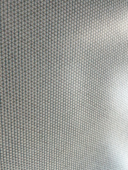 Closeup of a grey on white crosshatch-style pattern