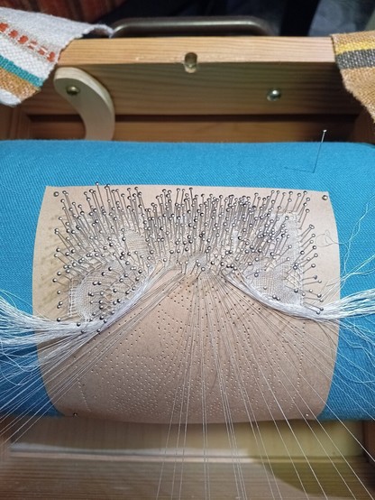 Bobbin lace pillow and beginning of lace