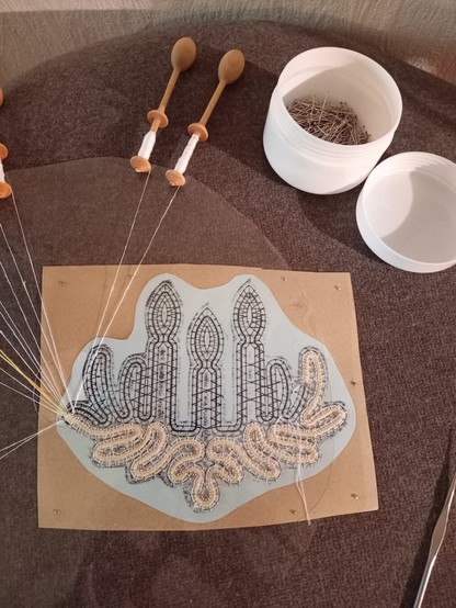 Bobbin lace pillow and beginning of lace