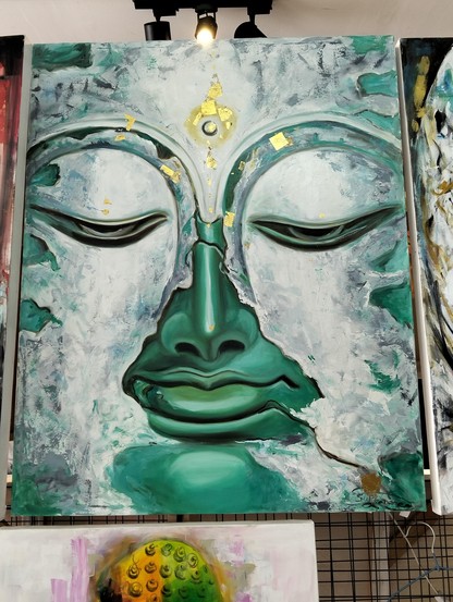 a  painting  of  a close-up of a large face, the skin is a metallic aqua color, white mineral clouds passing over it, the eyes of the face are low in meditation