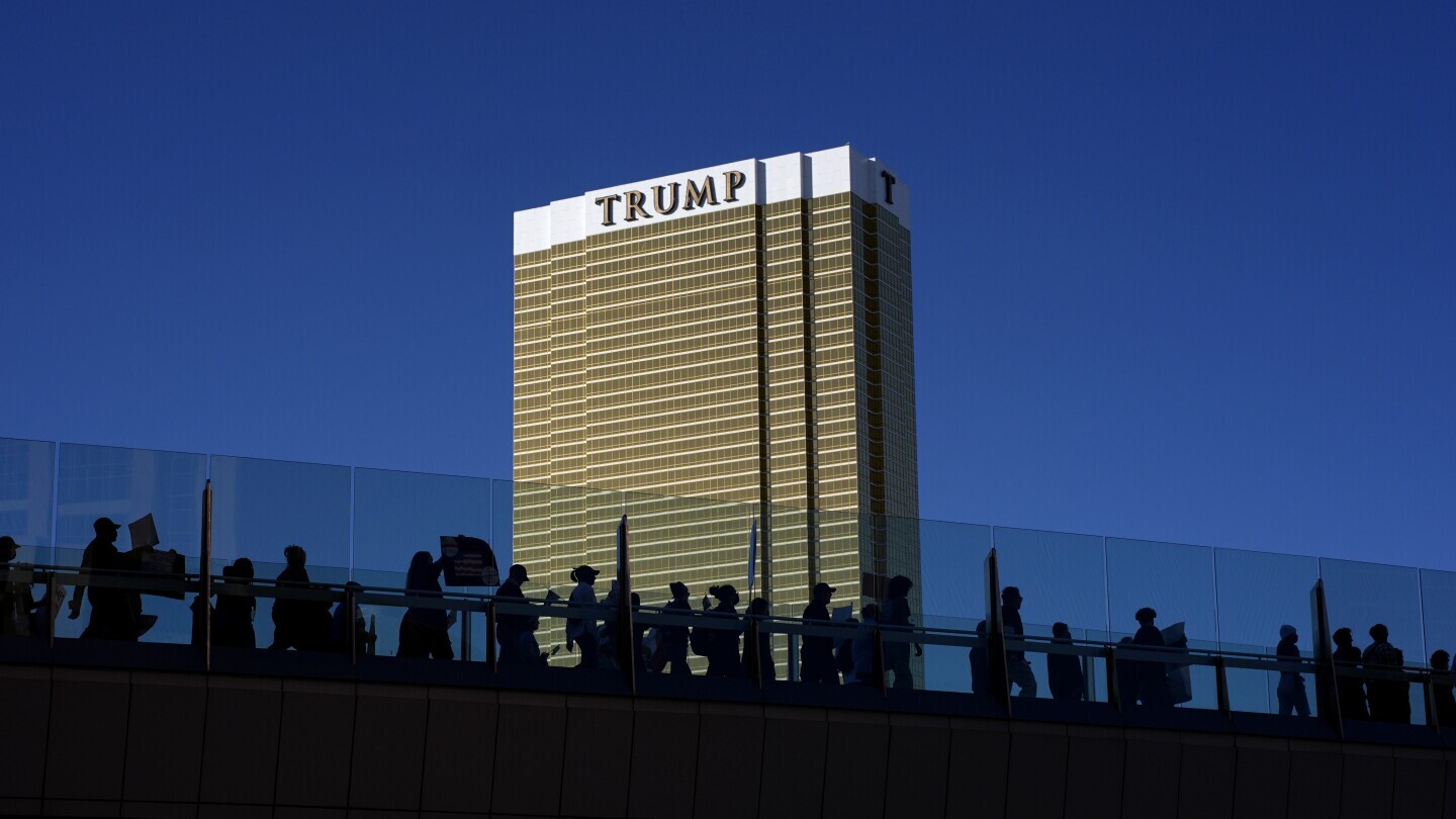 Demonstrators march to protest against the Trump administration near the Trump International Hotel along the Las Vegas Strip, Wednesday, Feb. 5, 2025, in Las Vegas. (AP Photo/John Locher)