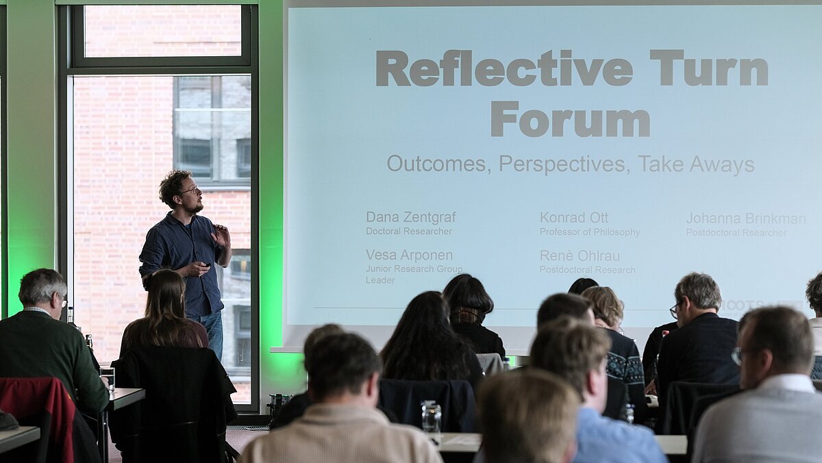 Lecture with slide on which Reflective Turn Forum is written Lecture with slide on which Reflective Turn Forum is written