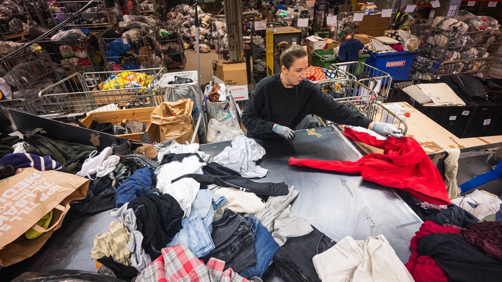 Sorting clothes in a recycling centre
