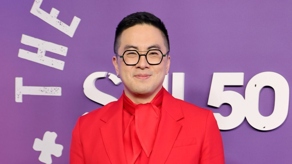 Bowen Yang poses on a red carpet.