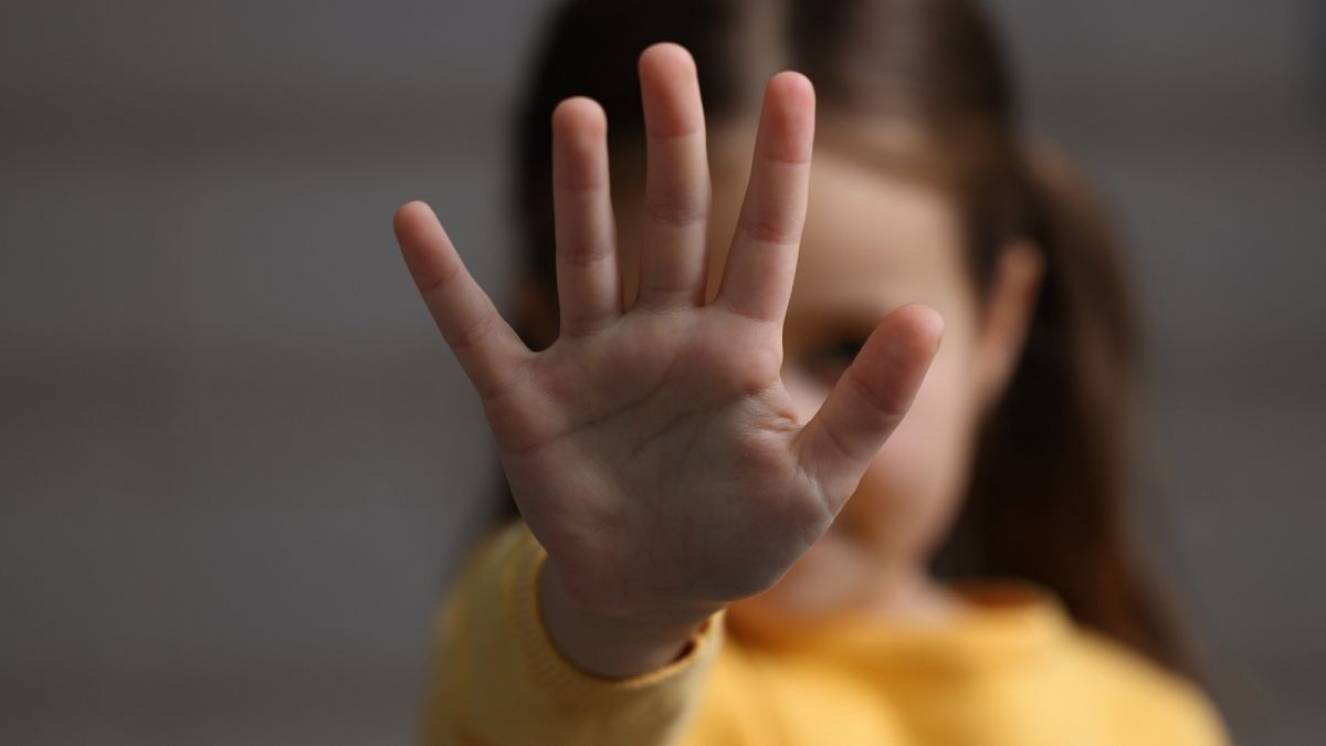A little girl doing stop gesture on gray background. | Olga Yastremska