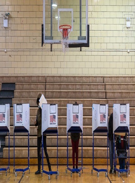 Voters in voting booths on election day.