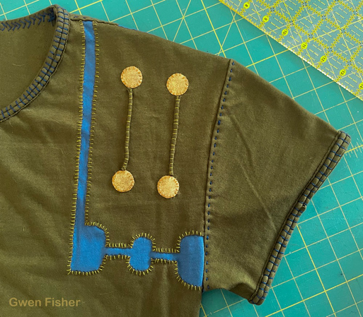 Detail of shirt shoulder shows large hand stitches. 