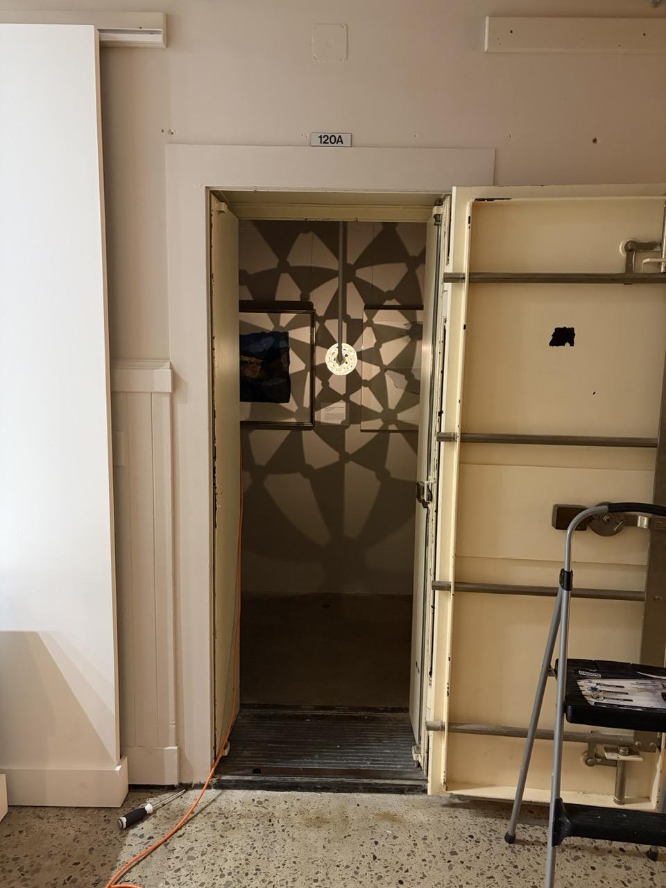 A doorway into the safe, with a pattern of light and shadow visible inside.
