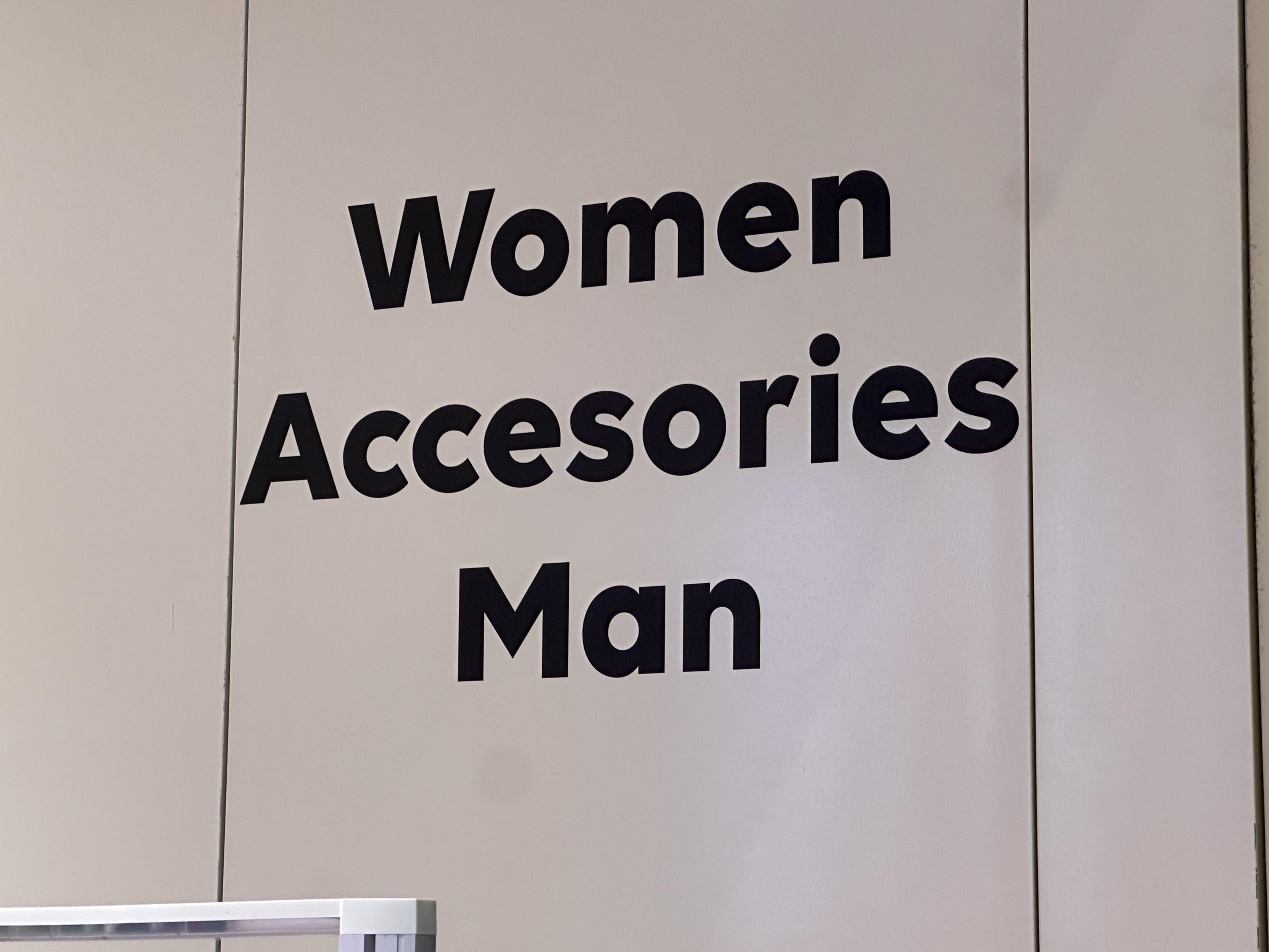 Text on the wall at the entrance of a shop, reading:
women
accessories
man