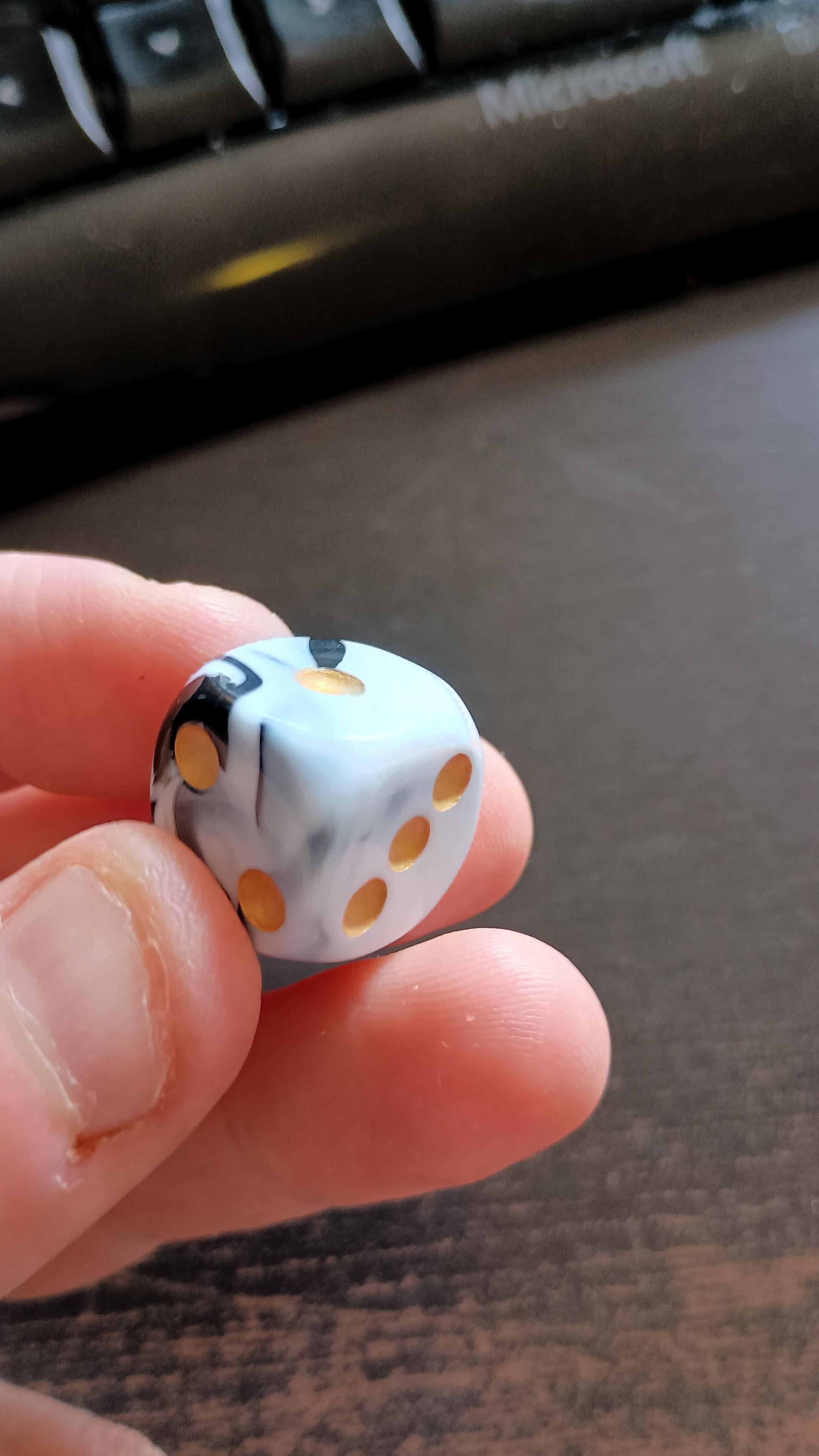 Standard die with 1 and 3 showing as in Revoy's picture, but on the left, instead of 6, is 2.