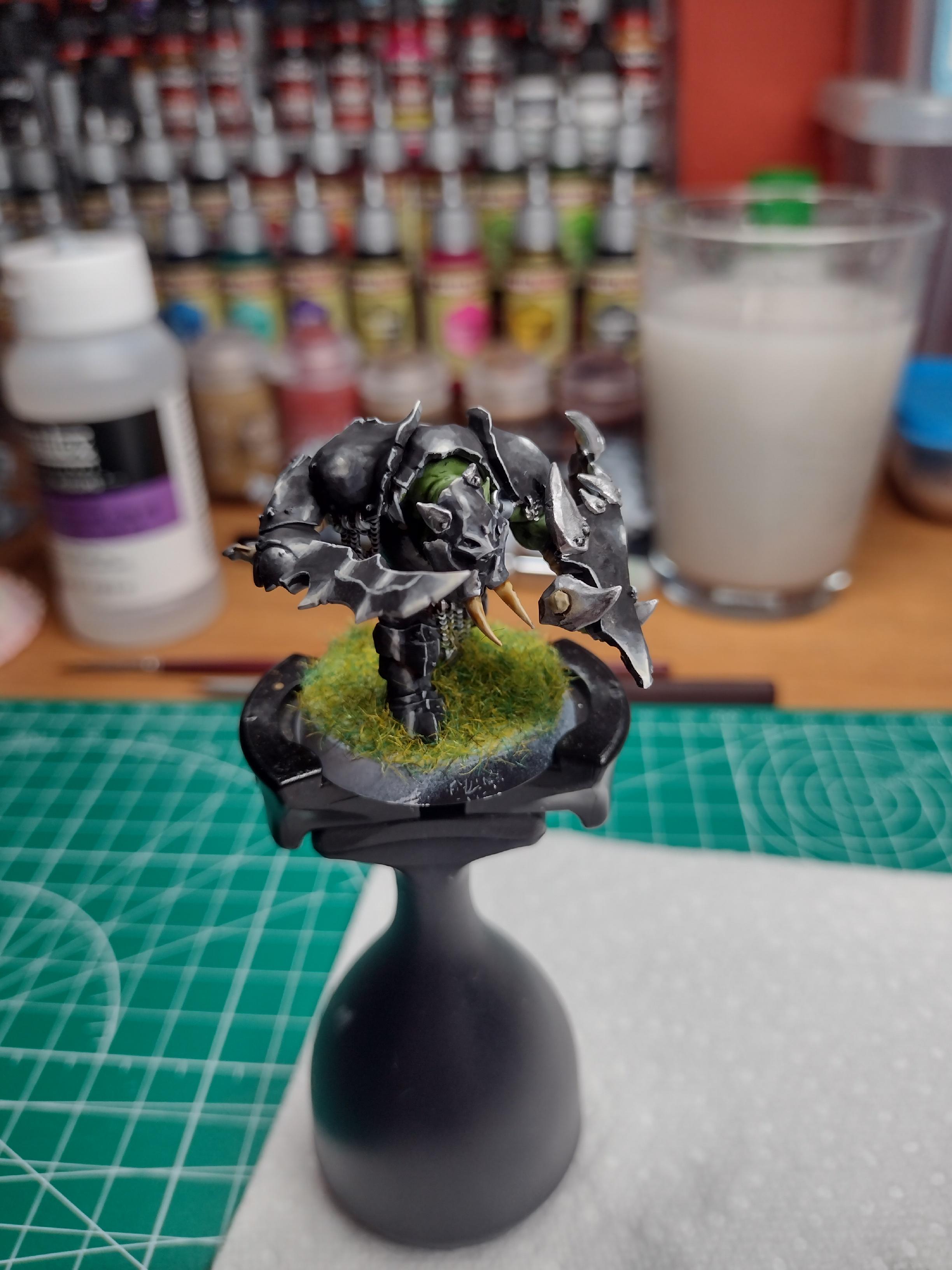 Orc miniature painted with a black armour.