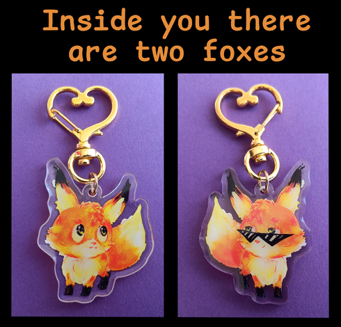 The text "Inside you there are two foxes" in orange. Below are two photos of the two sides of a cute fox charm, with heart-shaped hook on a violet piece of paper. In the left image, the fox is looking a bit shy. In the right one, it's wearing sunglasses and has a cool and determined expression.