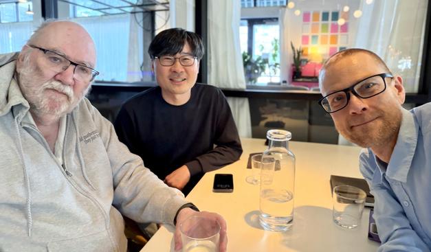 Dennis Stanton, Jang Soo Kim, and Dan Drake at a table at the EaTo restaurant in downtown Minneapolis.