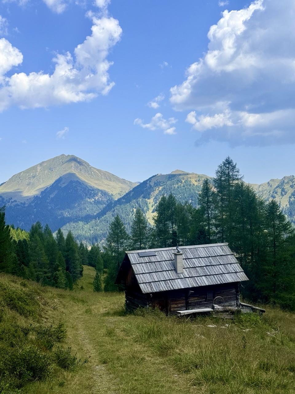 Photo of small house in alpine landscape